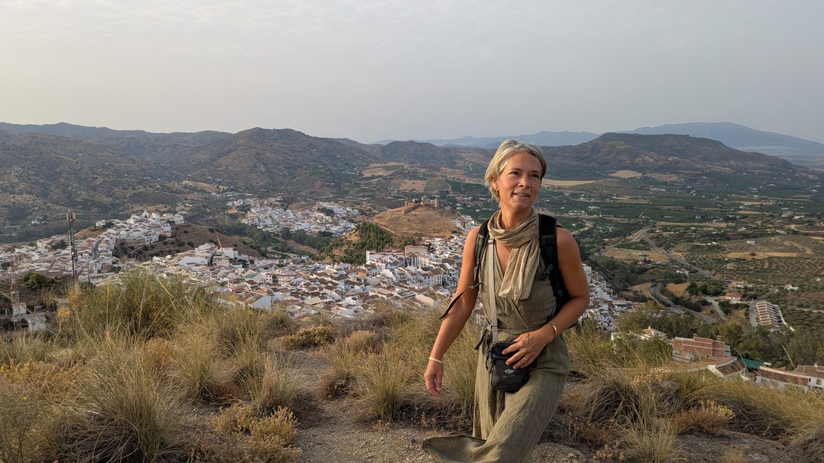 Ana Seahawk standing in the mountain landscape above the village